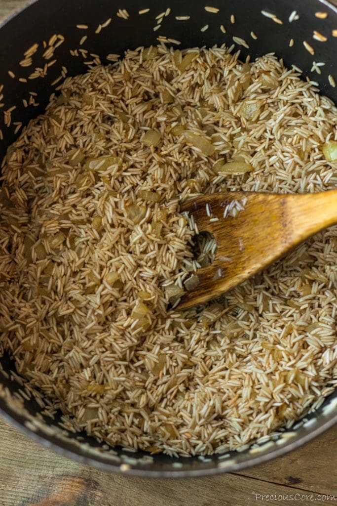 Rice, sauteed onion and oil in a pot