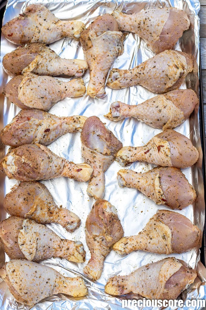 seasoned chicken drumsticks on a baking pan