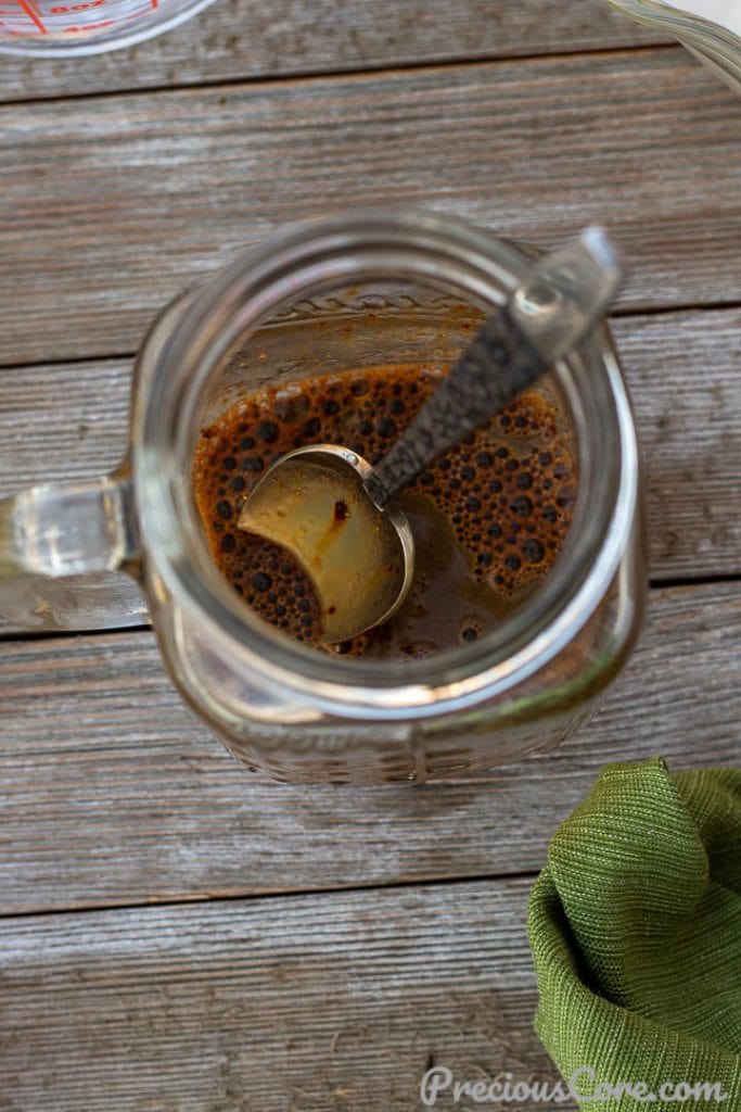 Instant coffee dissolved in a little water in a mug