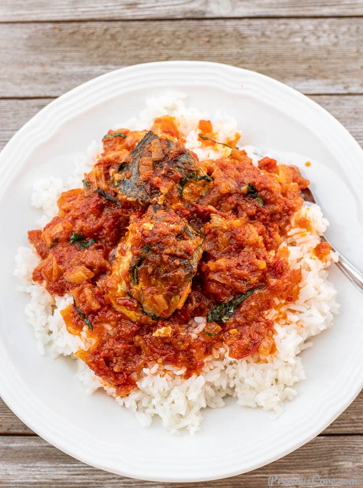 Rice in a plate with fish stew spread on top