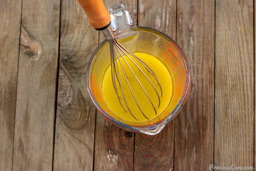 simple lemon vinaigrette in a measuring cup