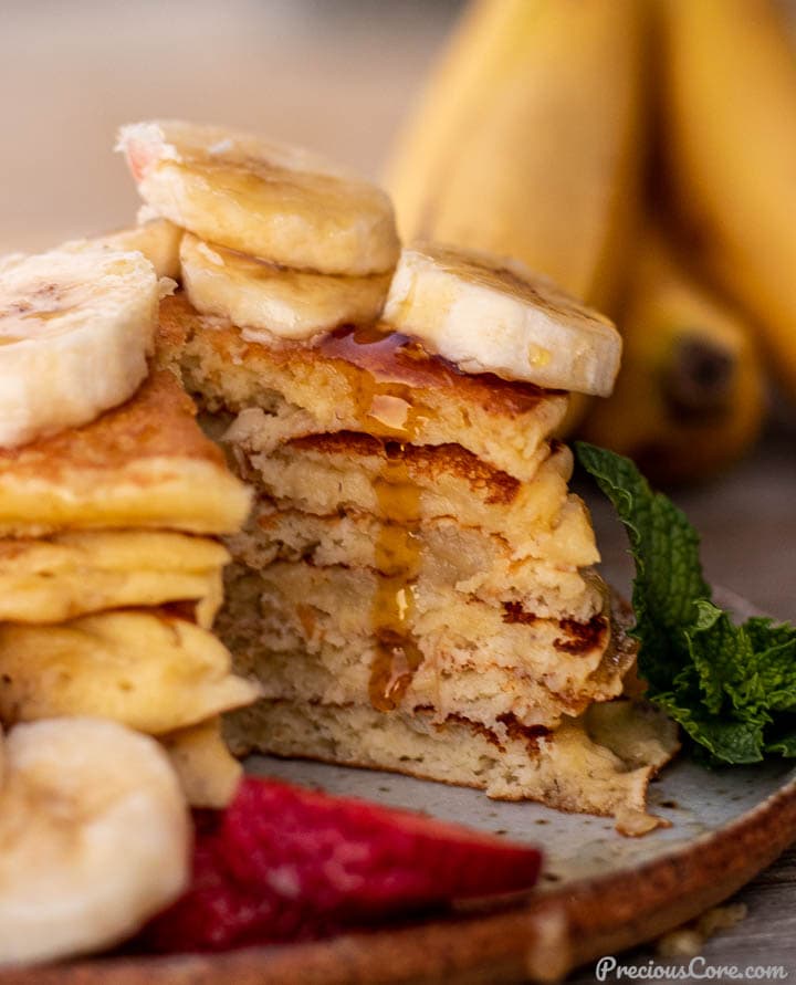 Banana Pancakes cut into with maple syrup dripping