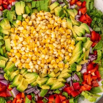 Corn, avocado and other vegetables for salad on a platter