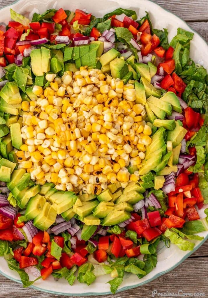Corn, avocado and other vegetables for salad on a platter