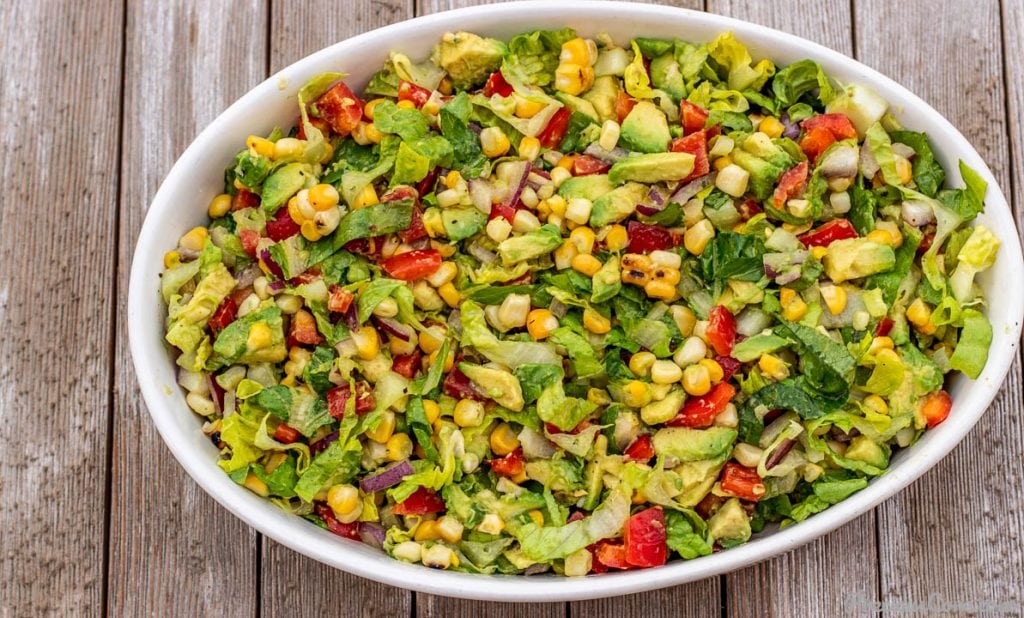 Tossed corn avocado salad in a bowl