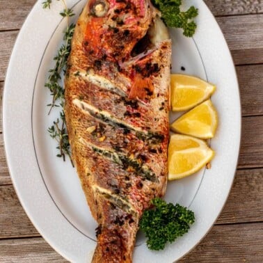 grilled red snapper on a platter