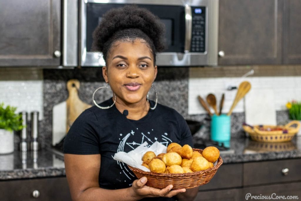 Woman holding basket of puff puff - Cameroonian Street Food