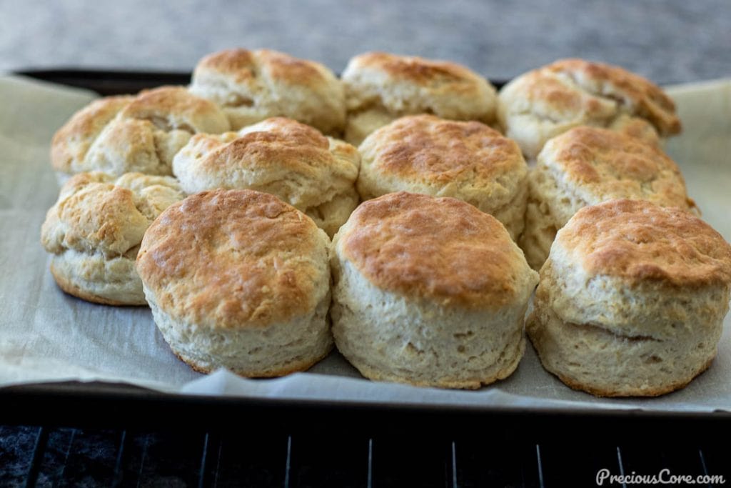 Freshly baked 3 ingredient biscuits on a baking sheet.