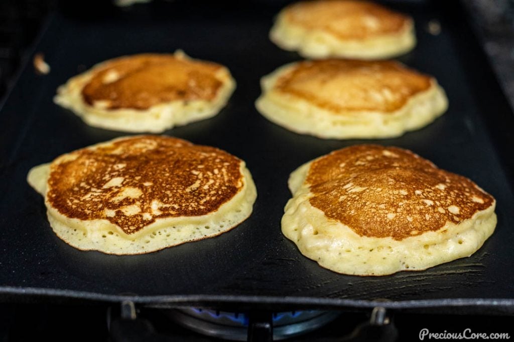 Banana Pancakes Cooking on Griddle