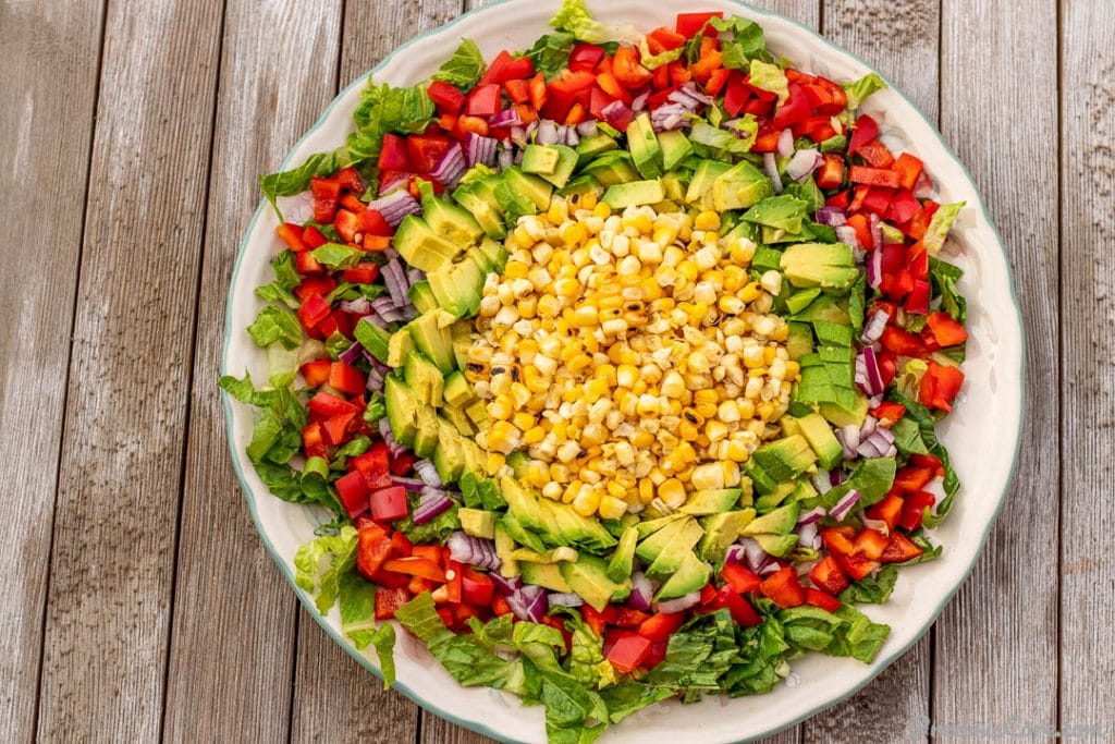roasted corn and avocado salad on a platter
