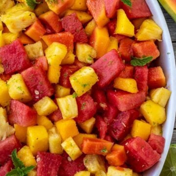 Tropical fruit salad in a serving bowl.