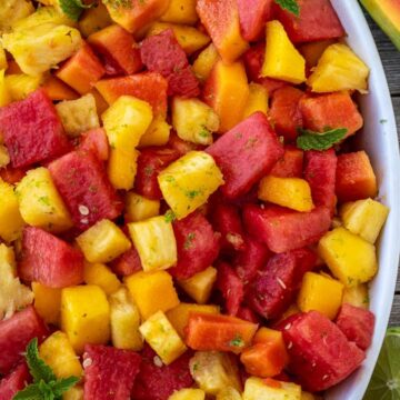 Tropical fruit salad in a serving bowl.