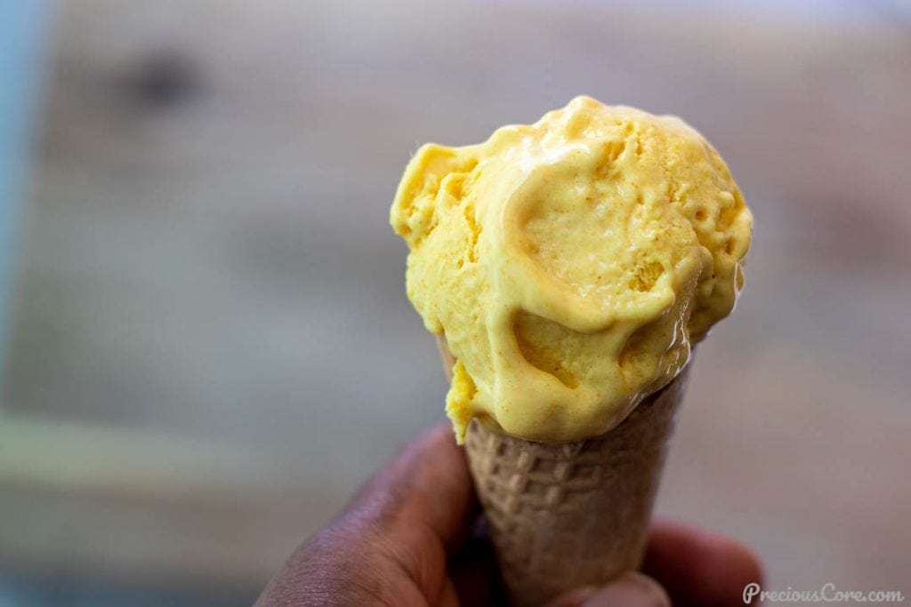 Hand holding cone of ice cream