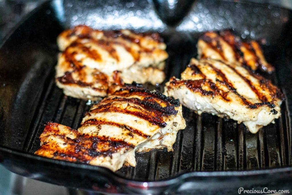 Chicken thighs grilling in grill pan