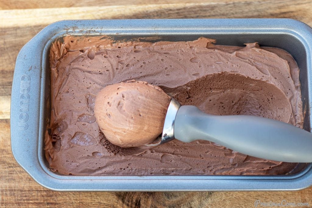 Scoop of ice cream in loaf pan filled with ice cream