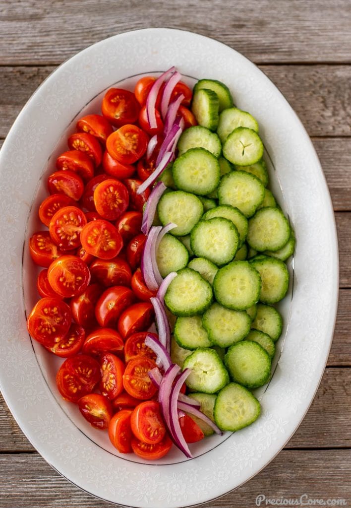Chopped cucumber, tomatoes and onions on a platter