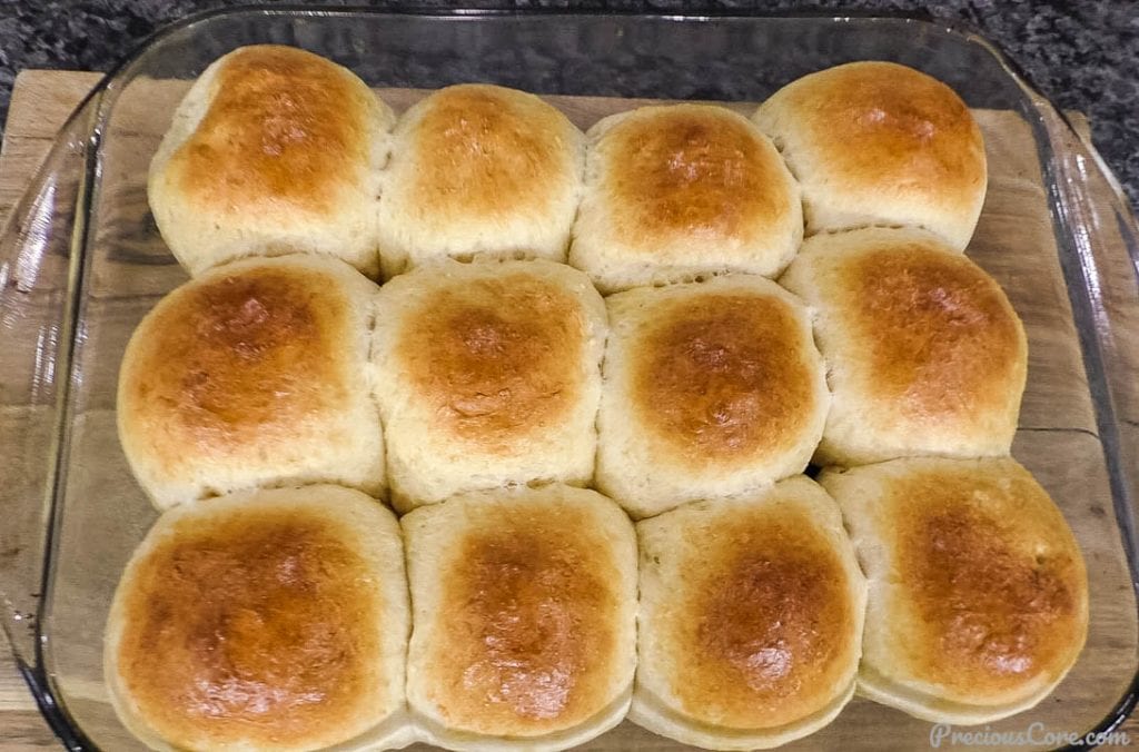 freshly baked golden brown dinner rolls in a baking dish