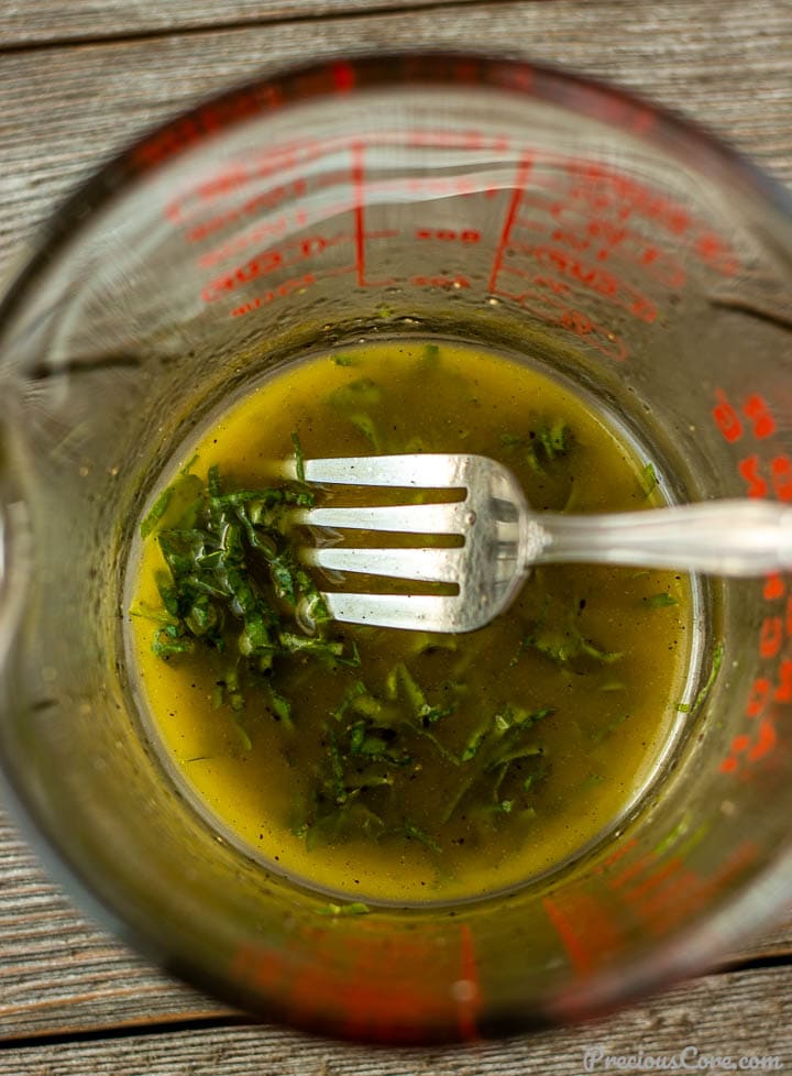 lemon basil salad dressing in a measuring cup