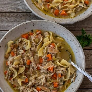 Two bowls of chicken noodle soup