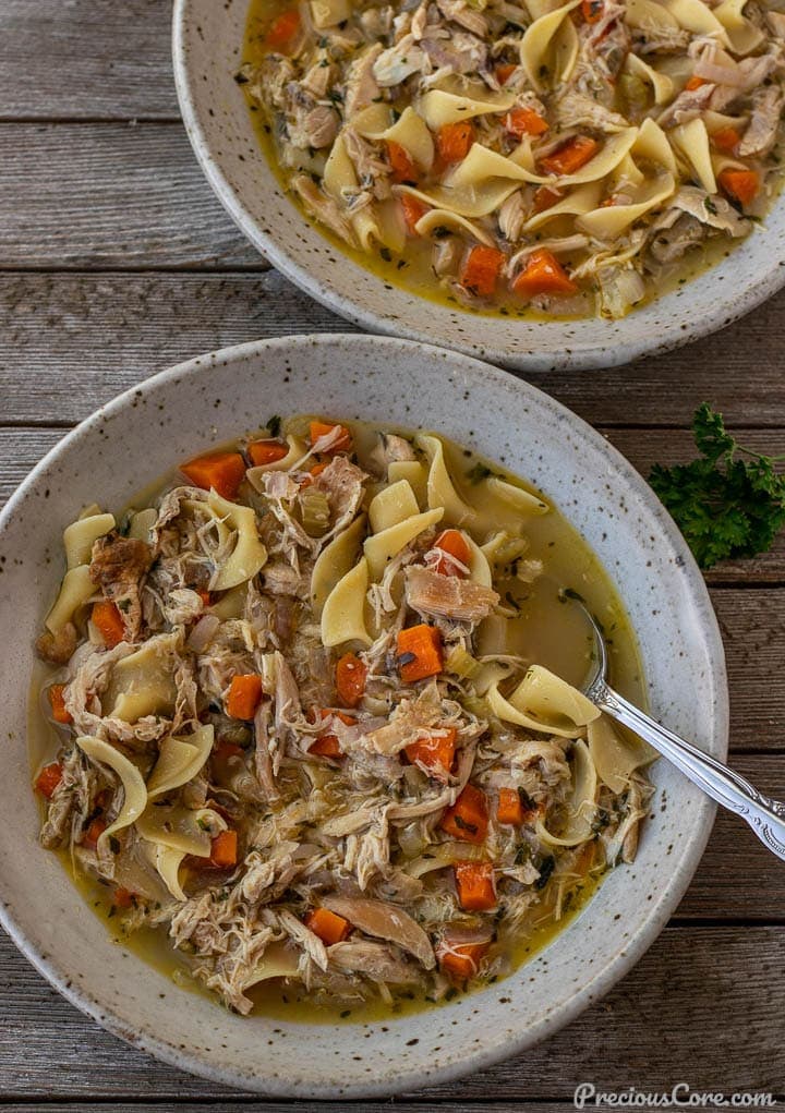 Two bowls of chicken noodle soup