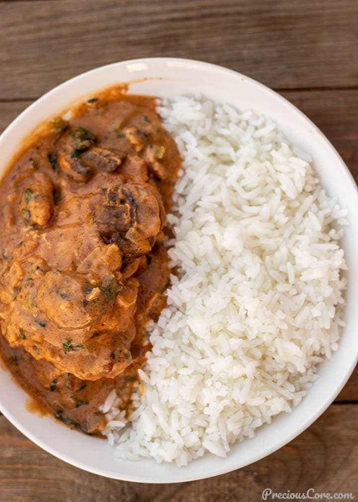 African chicken peanut stew and rice in bowl.