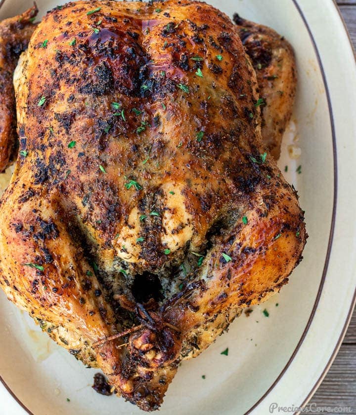 Whole herb roasted chicken on a platter