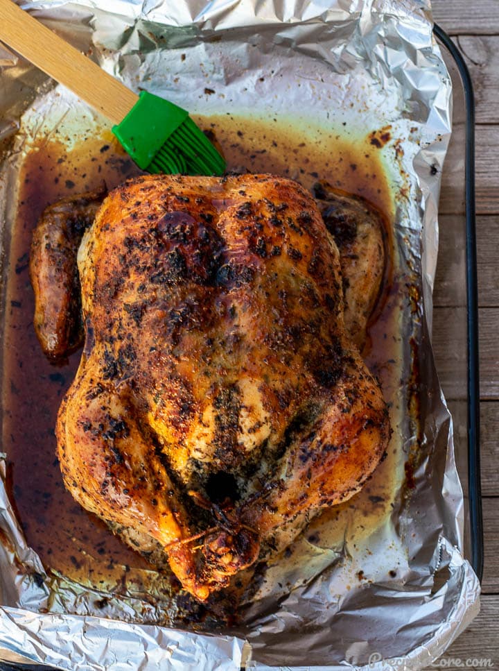 Golden brown roast chicken in baking dish