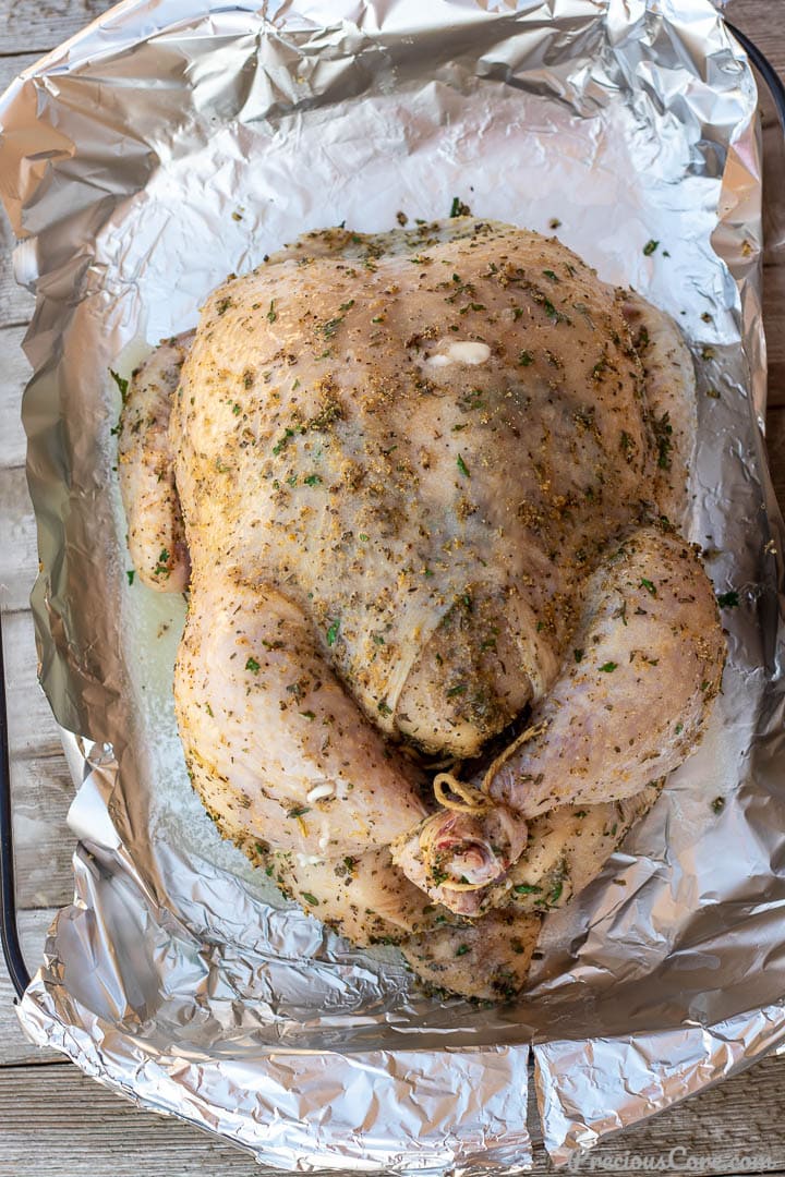 Seasoned whole chicken in a baking dish