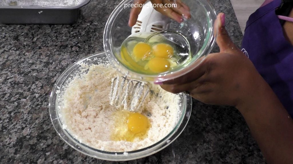 Hand holding bowl with eggs