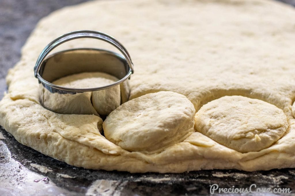 Biscuit rounds being cut out with a biscuit cutter