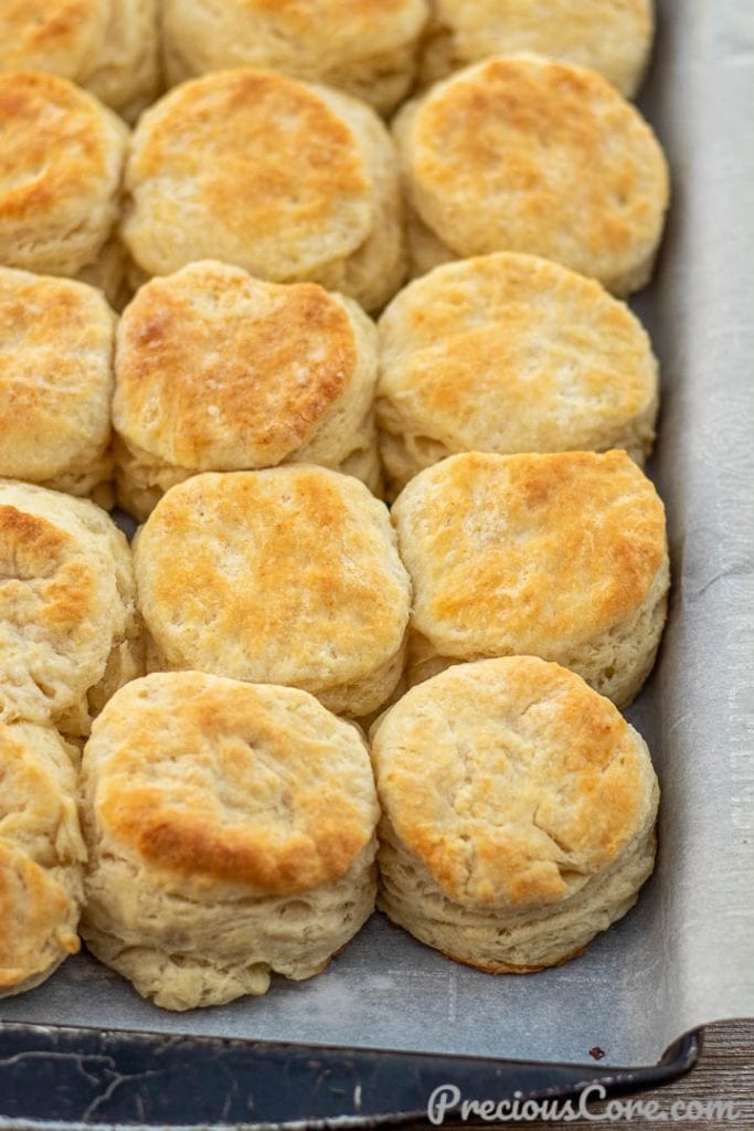 Baked buttermilk biscuits on parchment paper.