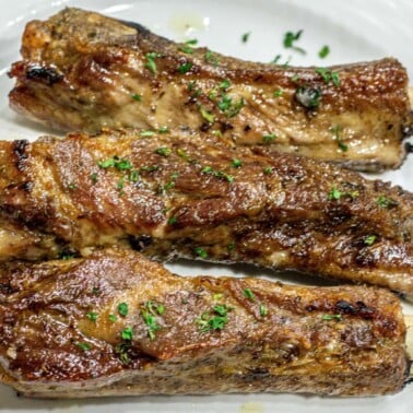 Square image of baked dry rub ribs.
