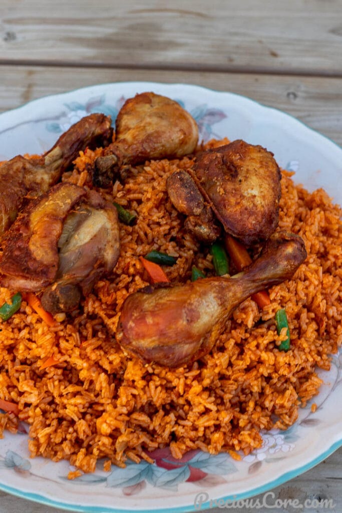Shot at another angle jollof rice with chicken on a platter