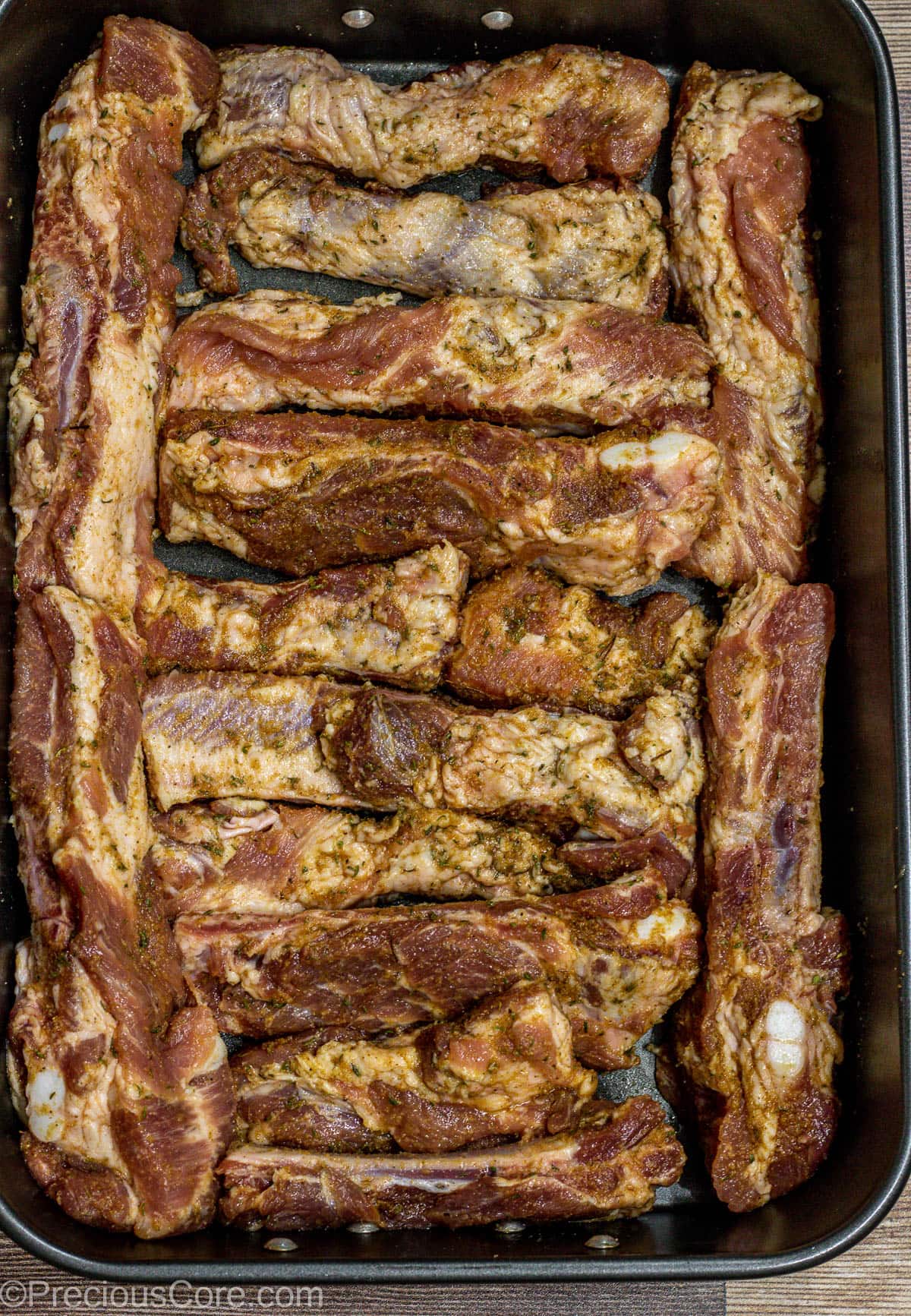 Seasoned Ribs in baking dish.