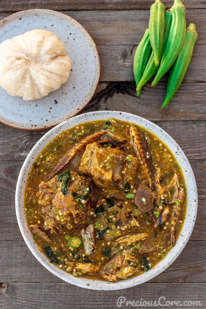 A bowl of African Okra Soup with a plate of Garri fufuf on the side