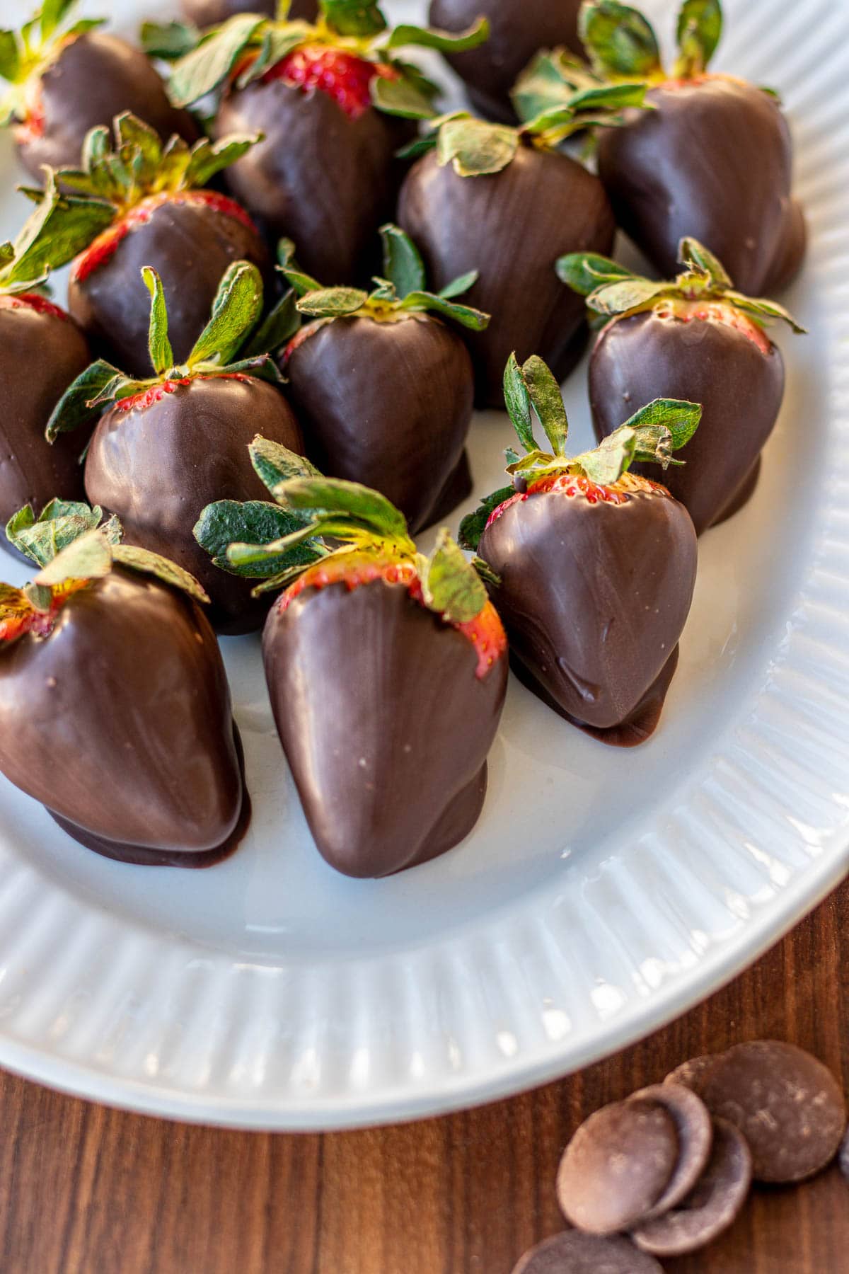 strawberries dipped in dark chocolate on plate