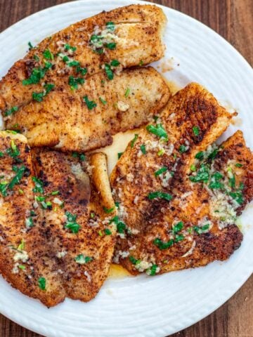 Lemon butter tilapia fillets on a plate