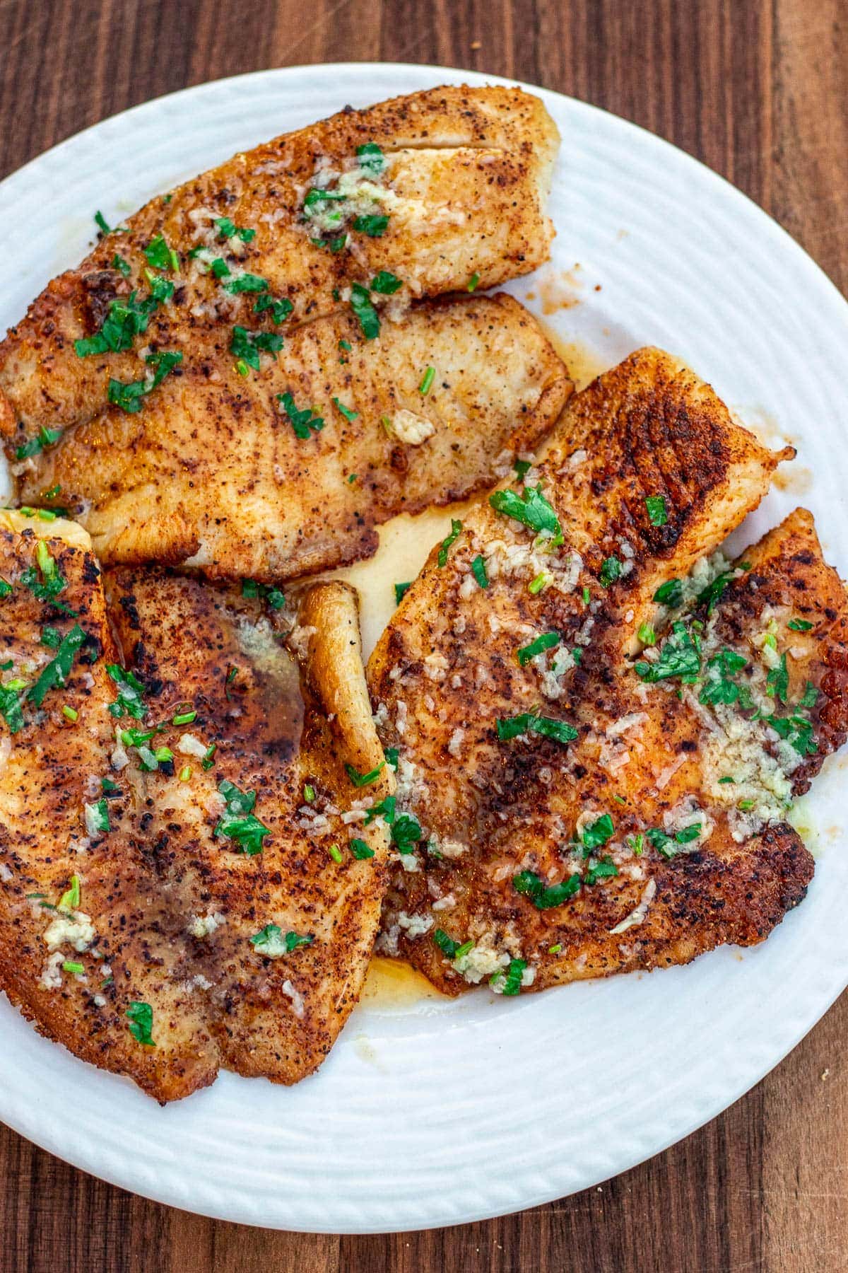 Lemon butter tilapia fillets on a plate