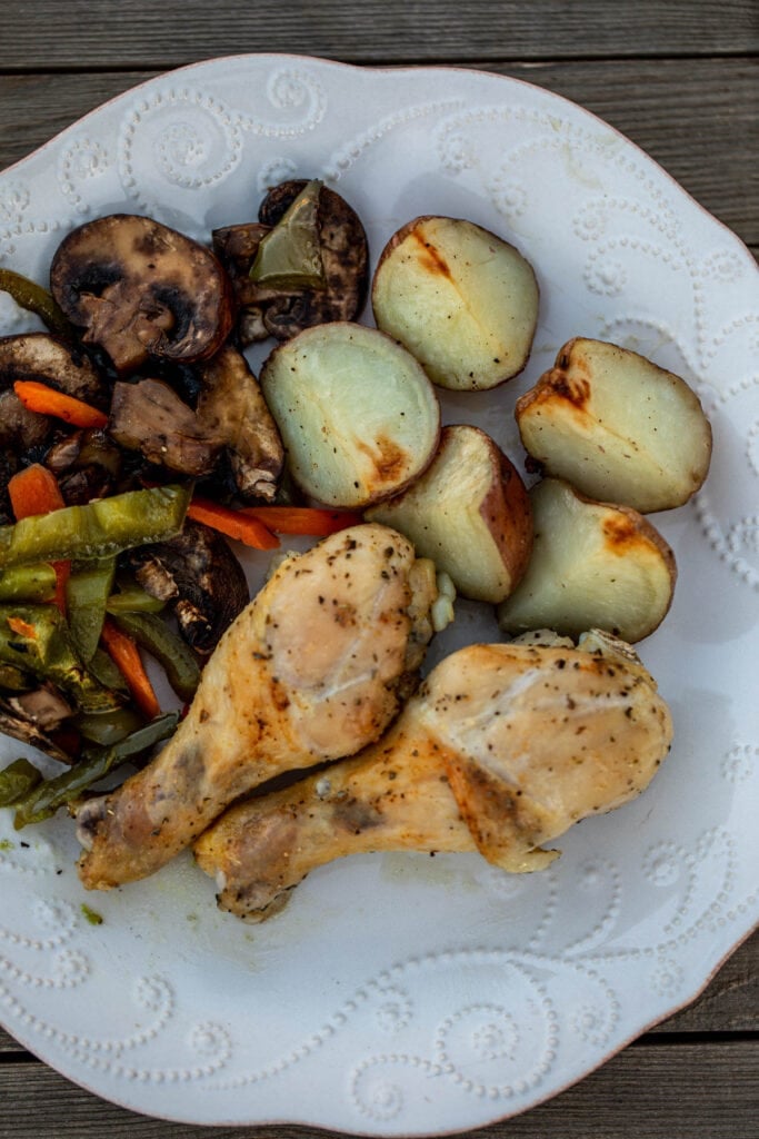 A plate of chicken potatoes and veggies