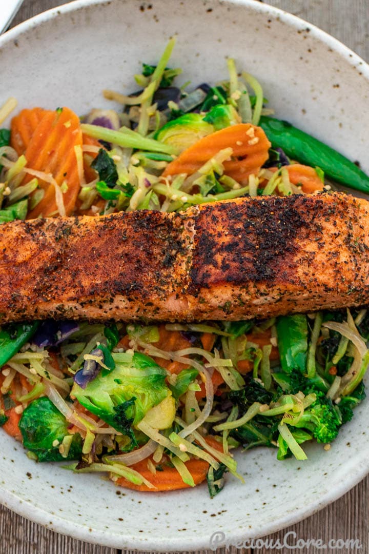 A plate with vegetables and salmon