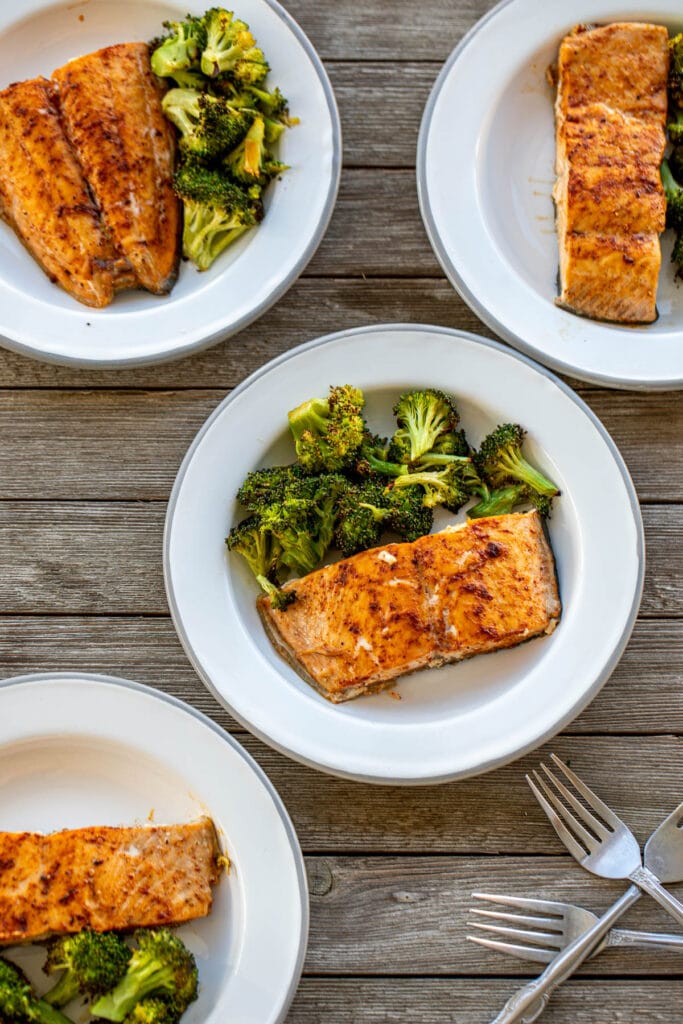 Different plates with salmon and broccoli