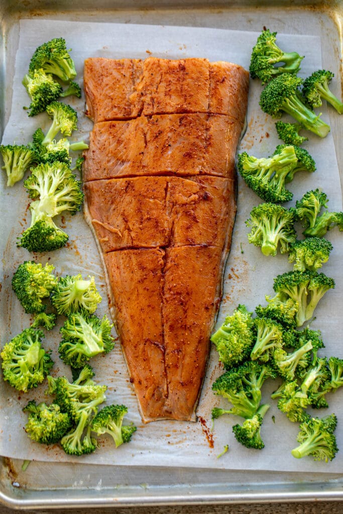 seasoned salmon and broccoli on a sheet pan