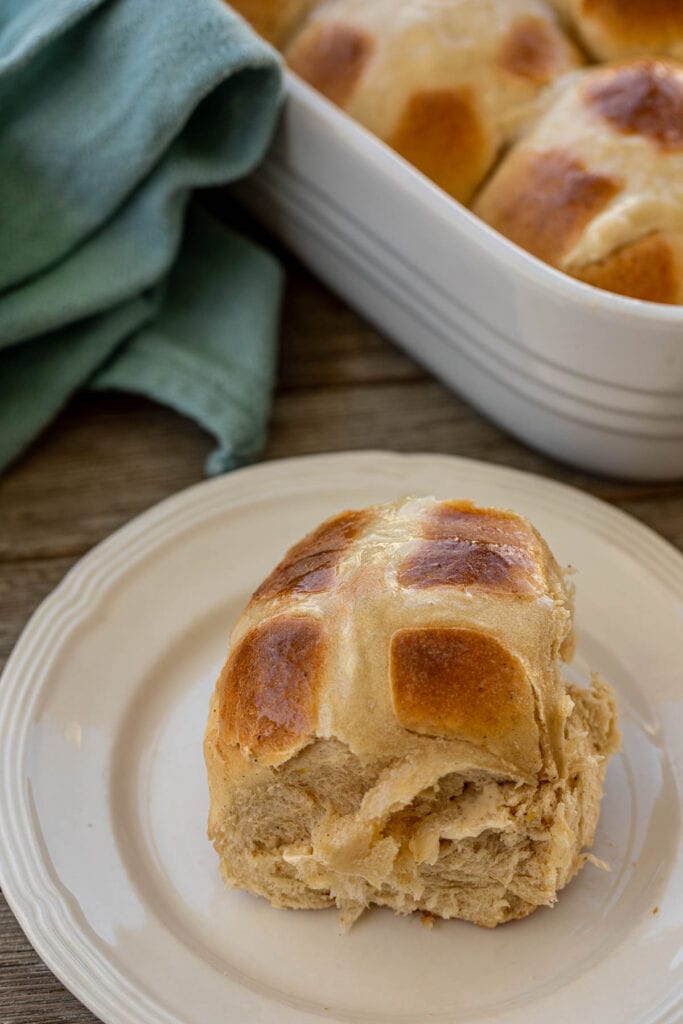 A sweet spiced bun on a plate 