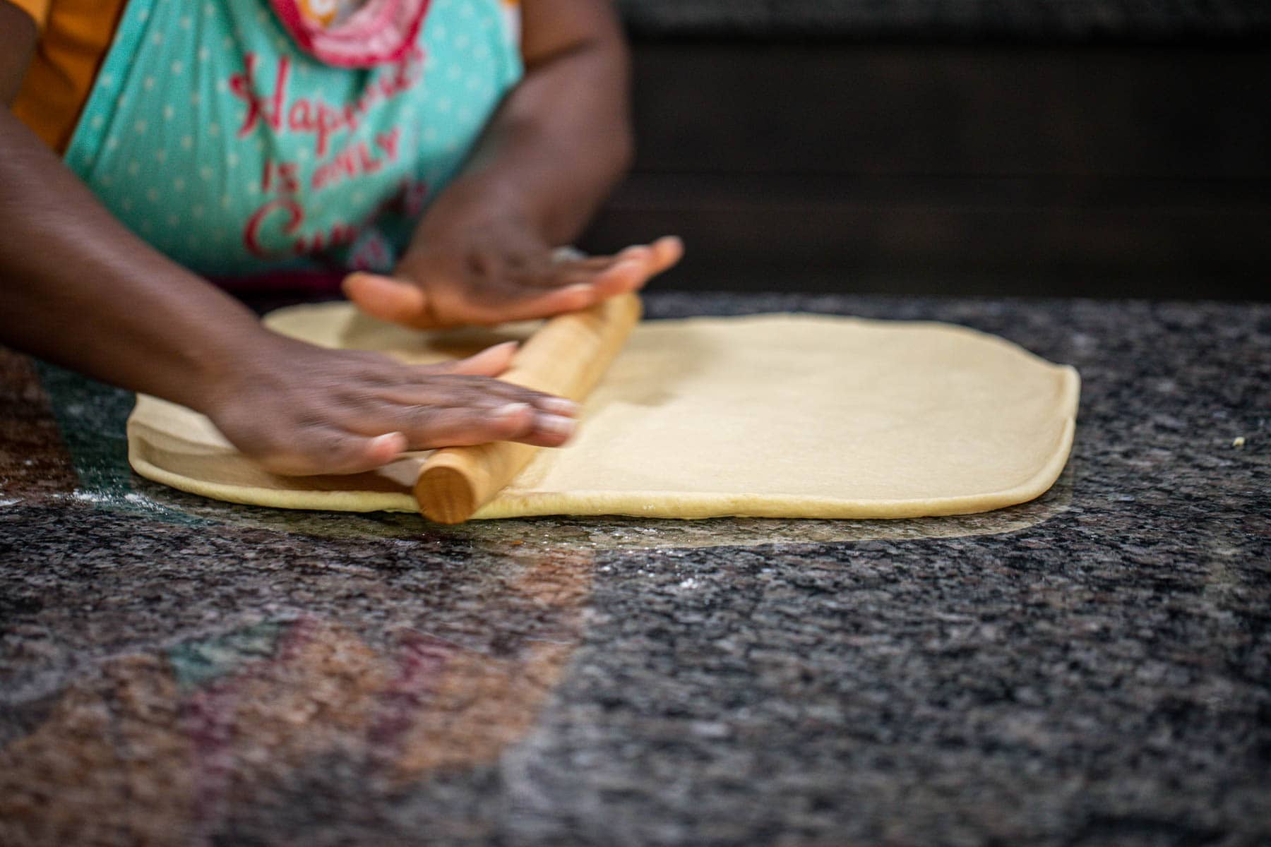 Hand rolling dough into a rectangle.