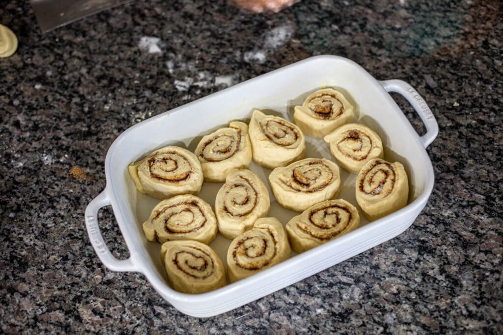 sweet spiced rolls in a white casserole pan