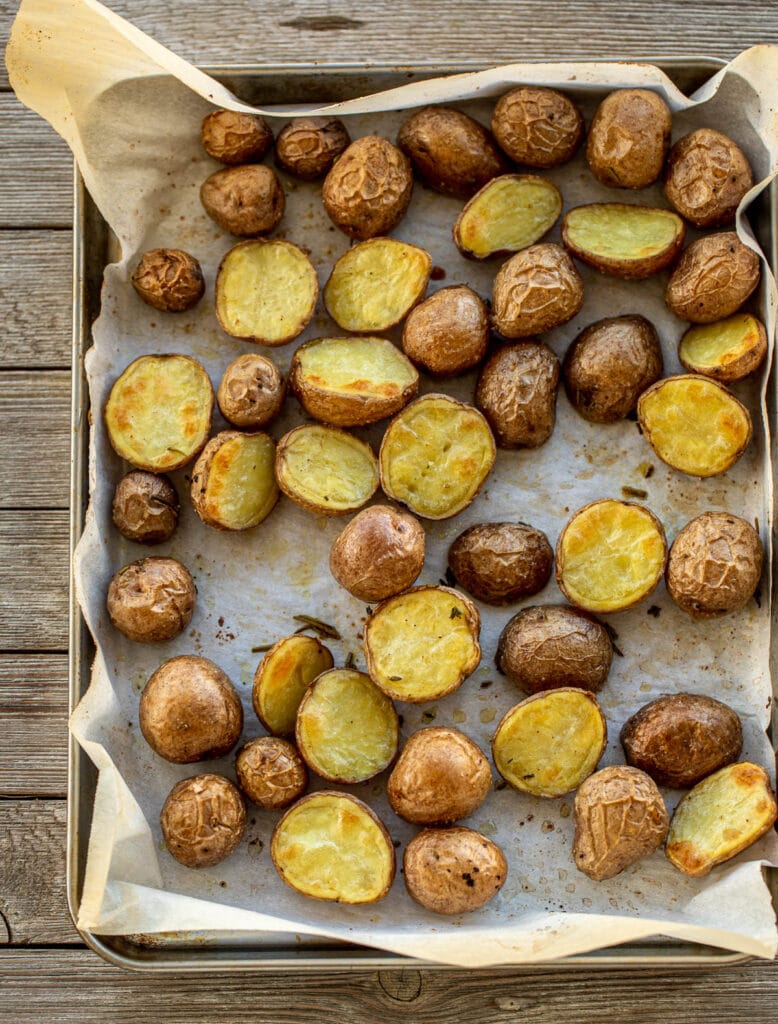 Baby potatoes on a baking sheet lined with parchment paper