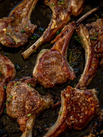 Pan seared lamb chops in a cast iron skillet