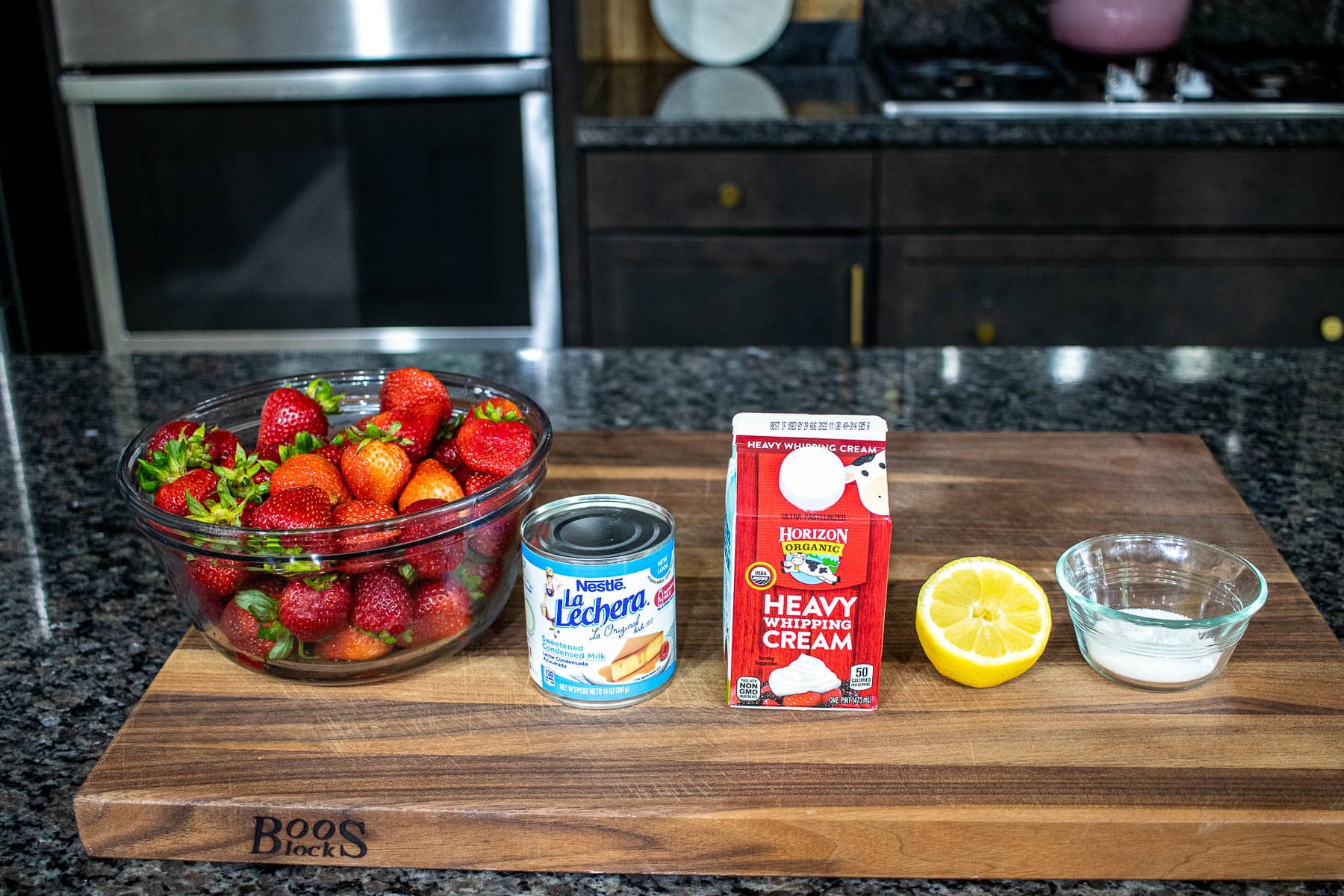 Ingredients for Homemade Strawberry Ice Cream on a chopping board