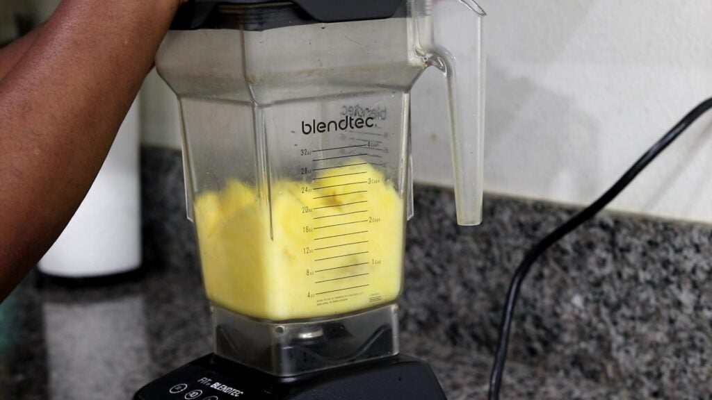 Pureeing pineapples in blender for lemonade