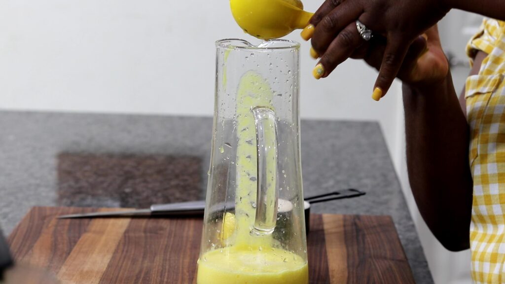 Squeezing lemon juice into a pitcher